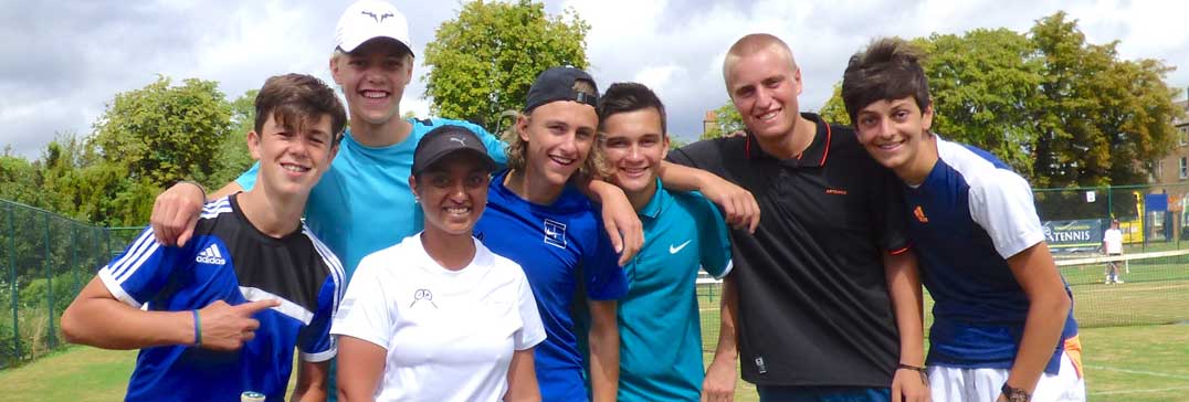 Trainee tennis coach with players